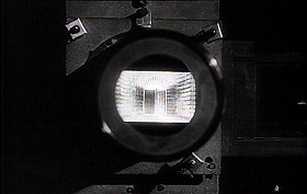 『審判』 1962　約1時間58分：《掟の門》を映すスライド・プロジェクターのレンズ